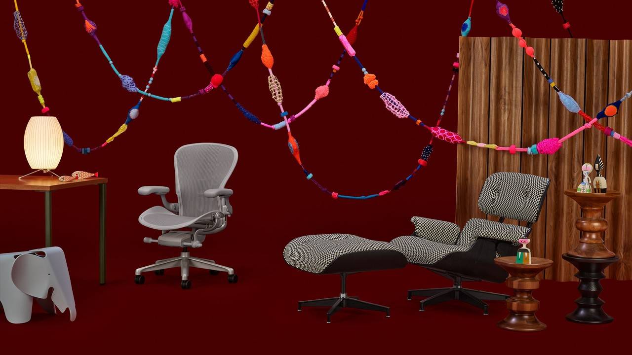 imagem de estúdio com um fundo vermelho vinho e móveis herman miller no cenário